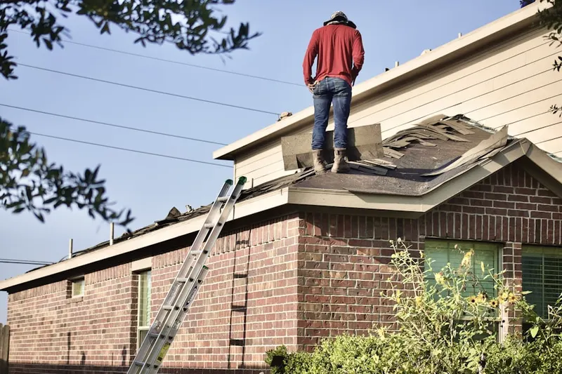 Professional roofer working on a residential roof in Swayzee